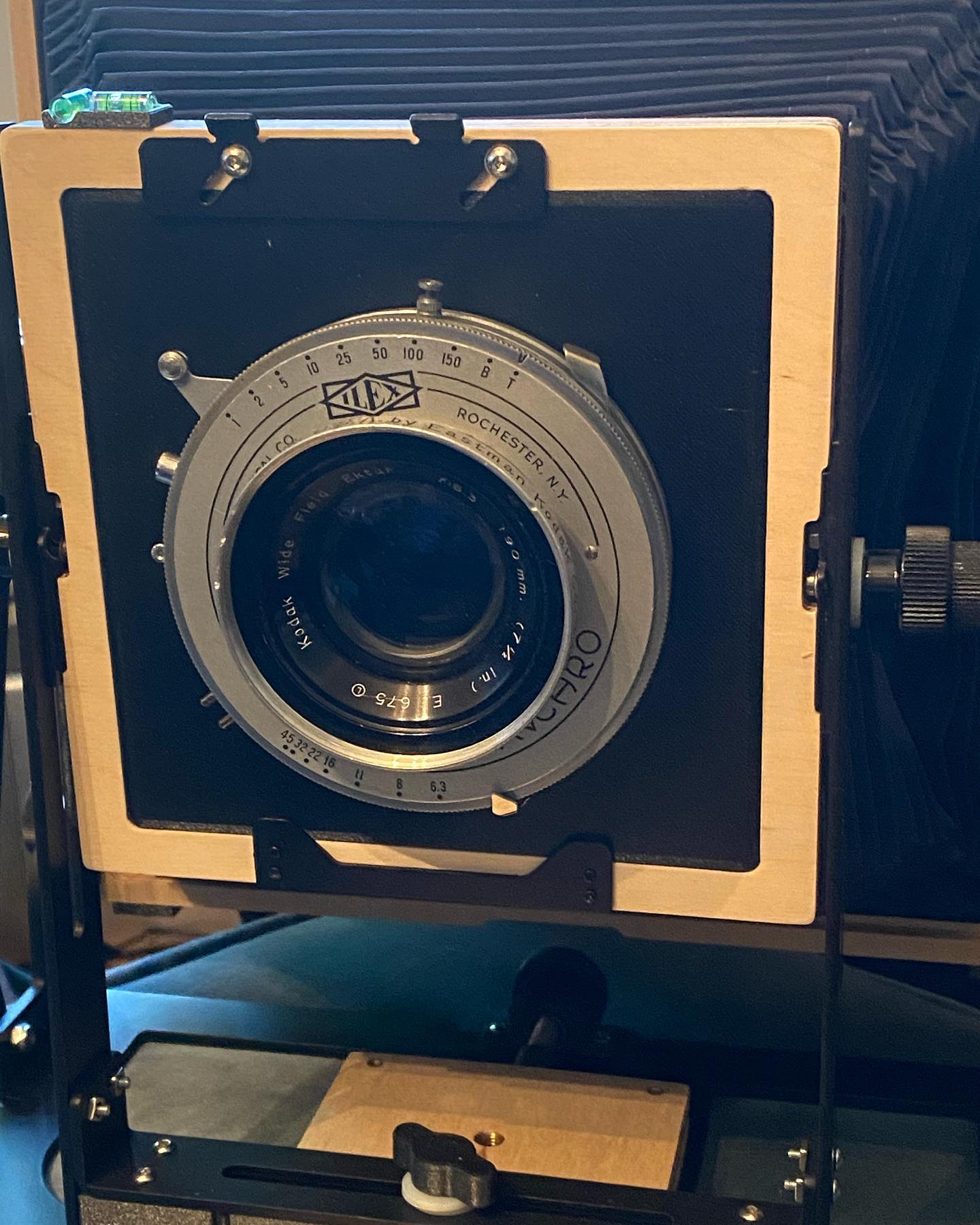 3D printed lens board for my @intrepidcamera 8x10. I had a hard time finding a board that would fit the Ilex No. 4 shutter that came with the Kodak Wide Field Ektar 190mm/f6.3 lens I picked up recently. So I opened up Fusion 360 and made one, which I then printed on my Ender 3 Pro. First attempt didnât work; the hole was based on some specs I read online and was too small, and I hadnât accounted for the rounded corners. Also it wasnât quite thick enough and so wasnât rigid enough. So back to Fusion 360, doubled the thickness to 4mm and added a circle to the back for another 2mm of support. The result looks promising. Will have to take the camera out this week and see if it worked.
